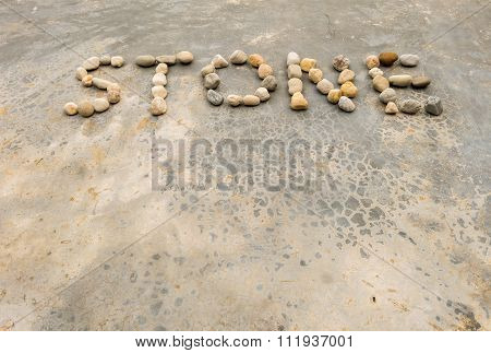 Closeup Text By Stone On Old Concrete Floor Texture Background In Vintage Tone