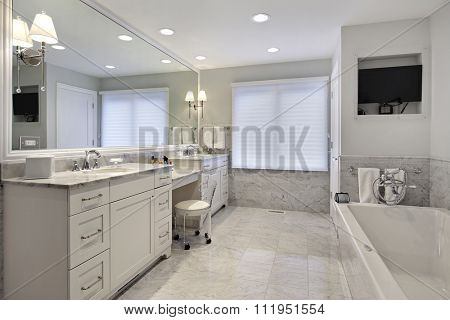 Master bath in suburban home with white cabinetry