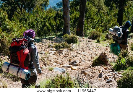 Girl and man Hikers with backpacks Trecking Down The Mountain Tajamulco