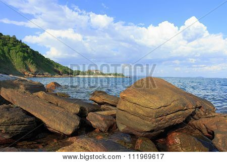 Rocks, Sea, Mountains And Blue Skies.
