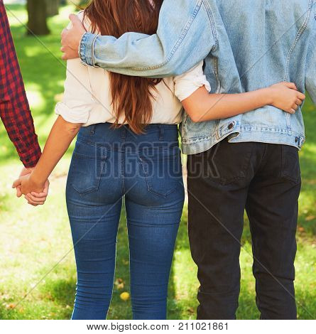 Friendship love jealousy adultery polygamy concept. Love triangle. Young woman in relationship with two men.