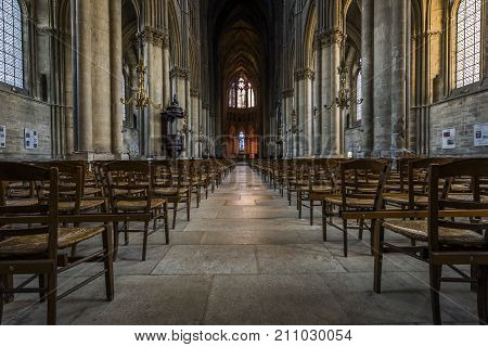 Reims France - June 12 2017: interior of the cathedral of Reims with many wooden chairs high pillars and a pulpitt France.