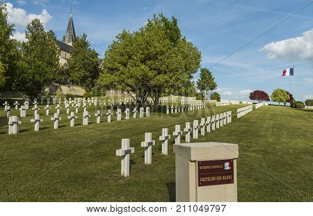 Chatillon-sur-Marne France - June 7 2017: War cemetery 1914-1918 of French soldiers in Chatillon-sur-Marne with French flag and church.