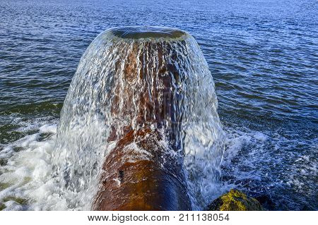 Vertical water flow from the pipe to the fish pond.