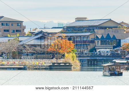 KYOTO JAPAN - NOVEMBER 24 2016 Togetsukyo bridge with the colourful forest mountain background during late autumn season Arashiyama Kyoto Japan.