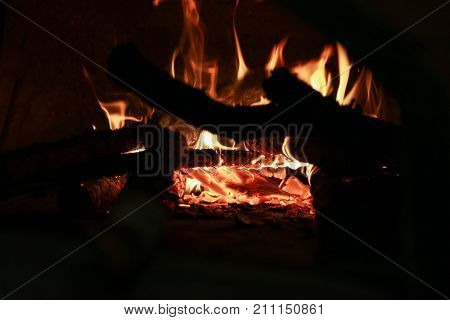 wood that burns in the oven whit dark background
