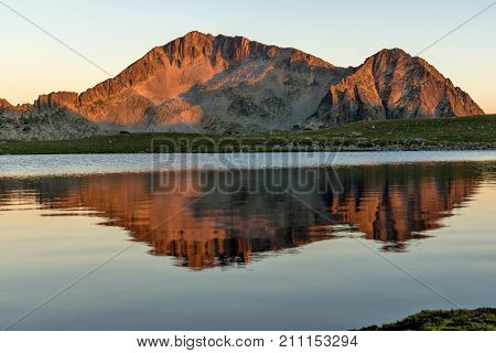 Amazing red Sunset landscape of Tevno lake, Pirin Mountain, Bulgaria