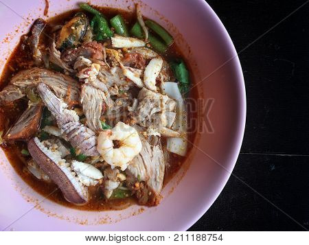 Noodles Seefood Tom Yum With Squid And Mantis Shrimp, Squid, Prawn In A Bowl On Wooden Table, Still