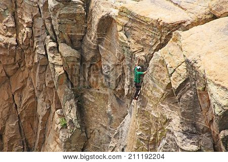 TUCSON, ARIZONA, USA --April 19, 2014:  Man top rope climbing a hoodoo near Windy Point on Mount Lemmon in Tucson, Arizona, USA in the Santa Catalina Mountains located in the Coronado National Forest with copy space.