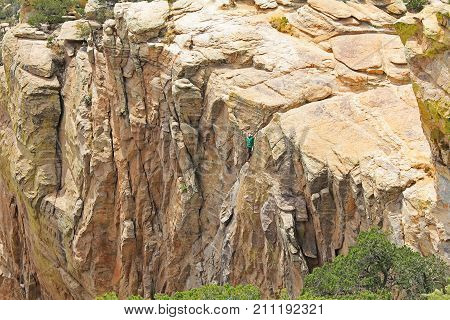 TUCSON, ARIZONA, USA --April 19, 2014:  Man top rope climbing a hoodoo near Windy Point on Mount Lemmon in Tucson, Arizona, USA in the Santa Catalina Mountains located in the Coronado National Forest with copy space.