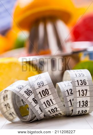 Measure Tape And Juicer With Citrus Fruits. Preparation Of Orange Grape Or Multivitamin Juice, Hands