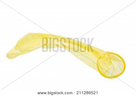 Used yellow condom isolated on white background.