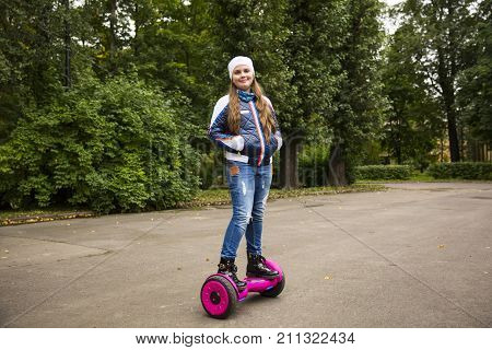 Child On Hover Board. Kids Riding Scooter In Park. Balance Board For Children. Electric Self Balanci
