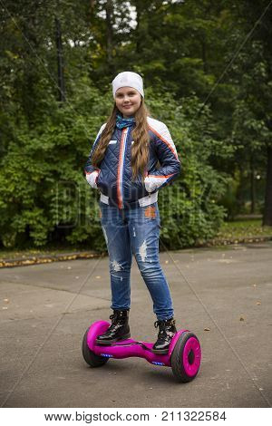 Child On Hover Board. Kids Riding Scooter In Park. Balance Board For Children. Electric Self Balanci