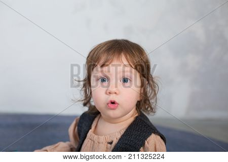 Little happy girl playing with toy on floor. Kindergarten.