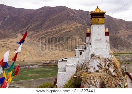 Yumbulakhang Palace, first building of Tibet, on the hill overlooking the rice field of Yarlung valley in Tsetang city - Tibet