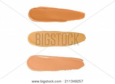 Swatches of a foundation of different shades isolated on a white background