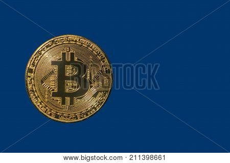 golden shiny coin bitcoin on a blue background