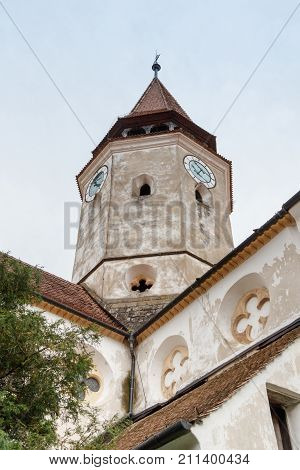 Fragment of the church and the watchtower with the clock of the Fortified Church Prejmer in Prejmer city in Romania