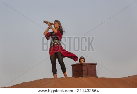 lady pirate in a desert with a treasure