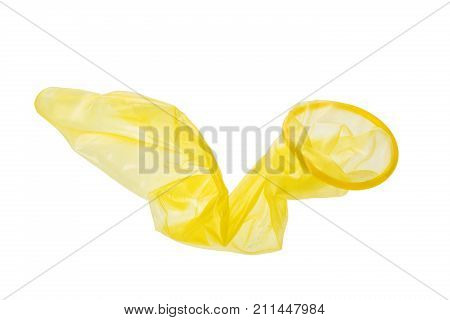 Used yellow condom isolated on white background.