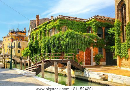 Houses Covered With Ivy Along Narrow Canal With Bridges In Venice, Italy.