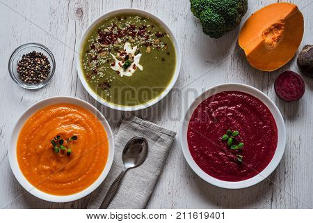 Different vegan food. Colorful vegetables cream soups and ingredients for soup. Healthy eating, dieting, vegetarian kitchen and cooking concept