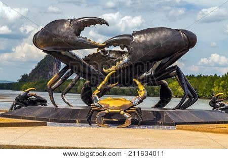 KRABI - 10 MARCH 2015: Crab statue in the cite centre town monument is located on the bank of the river of Krabi Thailand. Photo of Krabi landmark Kanaab Nam Cliff Krabi province.