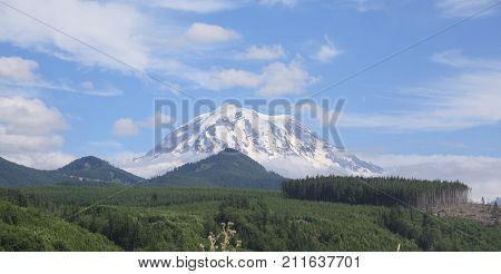 Mt Rainier in Washington state set against a blue sky