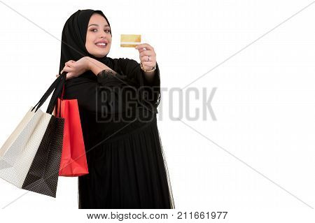 Happy of standing muslim woman with shopping bag and credit card isolated over white background.
