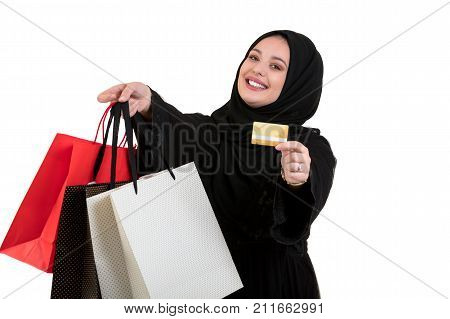 Happy of standing muslim woman with shopping bag and credit card isolated over white background.