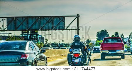 Police officer on motorcycle in 405 freeway in Los Angeles California