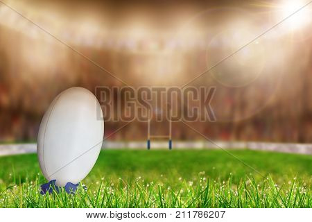 Rugby Ball On Tee In Stadium With Copy Space