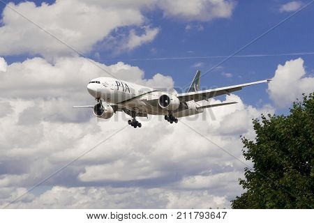 LONDON UK - AUGUST 3 2013; A Pakistan International Airlines (PIA) Boeing 777-240(ER) lands at Heathrow Airport in London