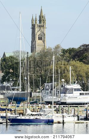 Fairhaven Massachusetts USA - November 1 2017: Unitarian Church towers over boatyard on Acushnet River in Fairhaven Massachusetts
