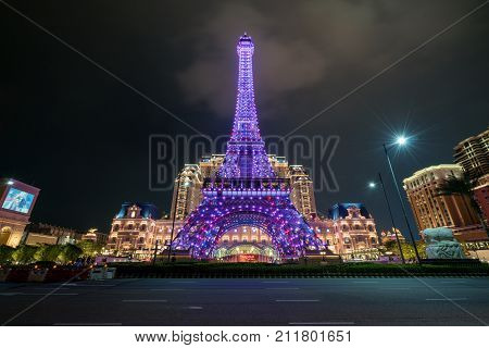 Macau China - Oct 15 2017: Perspective view of pink Macau Eiffel Tower icon of The Parisian a luxury Resort Hotel Casino in Cotai Strip owned by Las Vegas Sands shines bright at night.