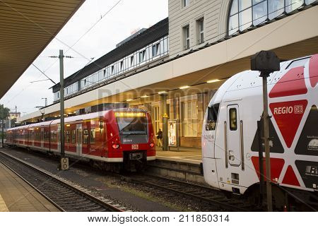 People Walk And Wait With Train Running In Terminal For Send And Receive Passengers At Mannheim Haup