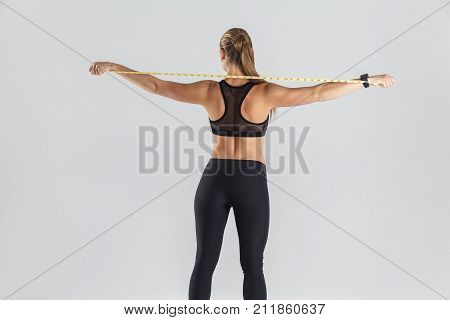 Back View Fitness Woman In Sportswear, Holding Centimeter