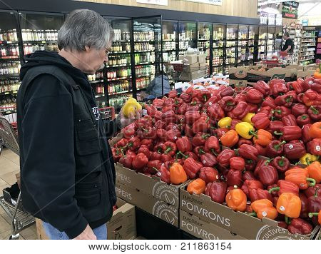 Altoona Wisconsin October 29 2017 Senior man shopping in the produce section of a modern Grocery store