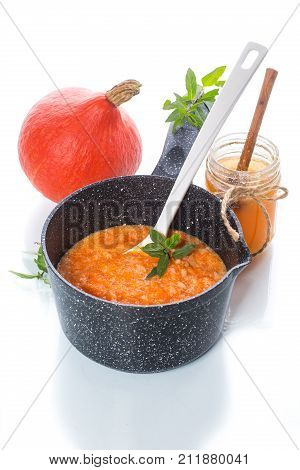 sweet pumpkin porridge with honey on a white background