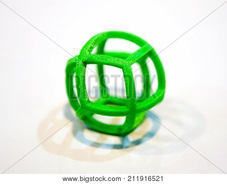 Abstract object of a green color printed by 3d printer on white background. Fused deposition modeling, FDM. Progressive modern additive technology. Concept of 4.0 industrial revolution