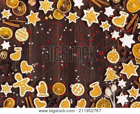 Gingerbread cookies christmas new year oranges cinnamon on wooden table with copyspace. Festive sweet pastry delicious food. Various cookies gingerbread man star heart christmas ball sock