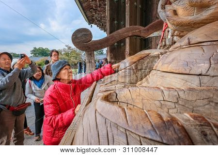 Nara, Japan - October 29 2018: Unidentified Senior Asian Woman With Binzuru - The Healing Buddha At 