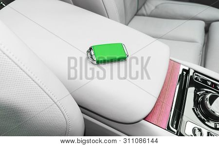 Closeup Inside Vehicle Of Wireless Green Leather Key Ignition On White Leather Seat. Wireless Start