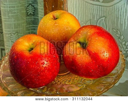 Bright Yellow-red Apples Are Washed With Water. The Appetitic Dessert On The Dish.