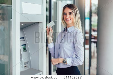 Business Woman Using Atm. Person Using Credit Card To Withdrawing Money From Atm Machine.
