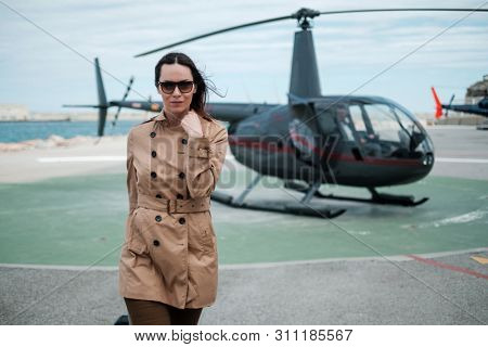 Business woman near private a helicopter