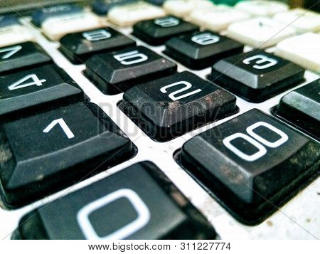 A Picture Of Used Calculater Keypad With Blur Background