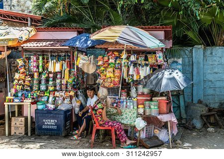 Puerto Princesa, Palawan, Philippines - March 3, 2019: Closeup Of Two Colorful Merchant Boots Near P
