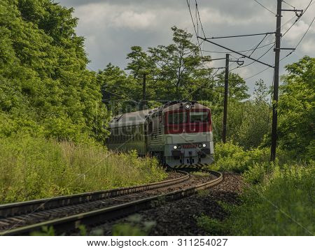 Passenger Diesel Red Big Train Near Kysak Station In Summer Hot Blue Sky Morning